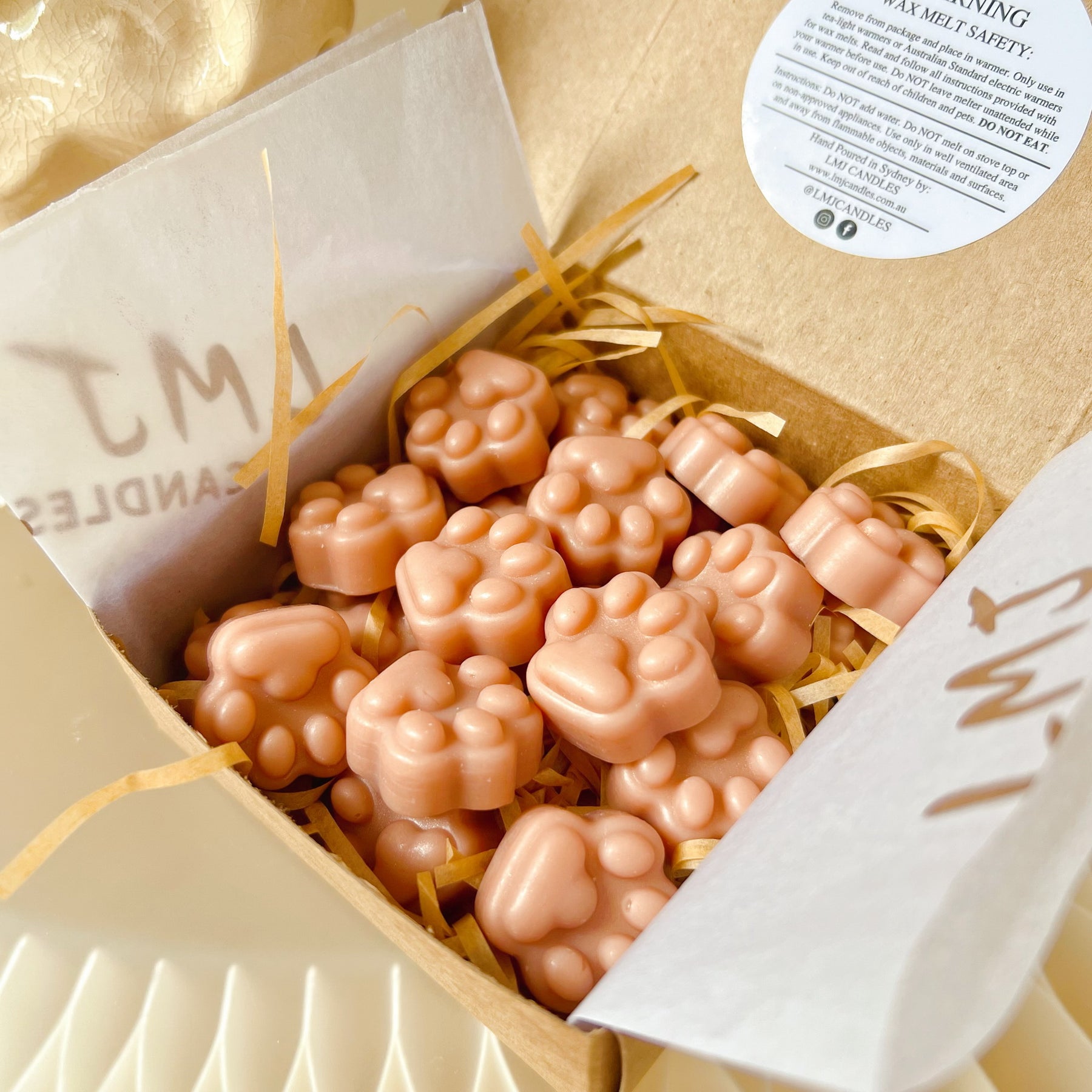 Eco-friendly, recyclable packaging of the paw-shaped soy wax melts from LMJ Candles, emphasizing sustainability.