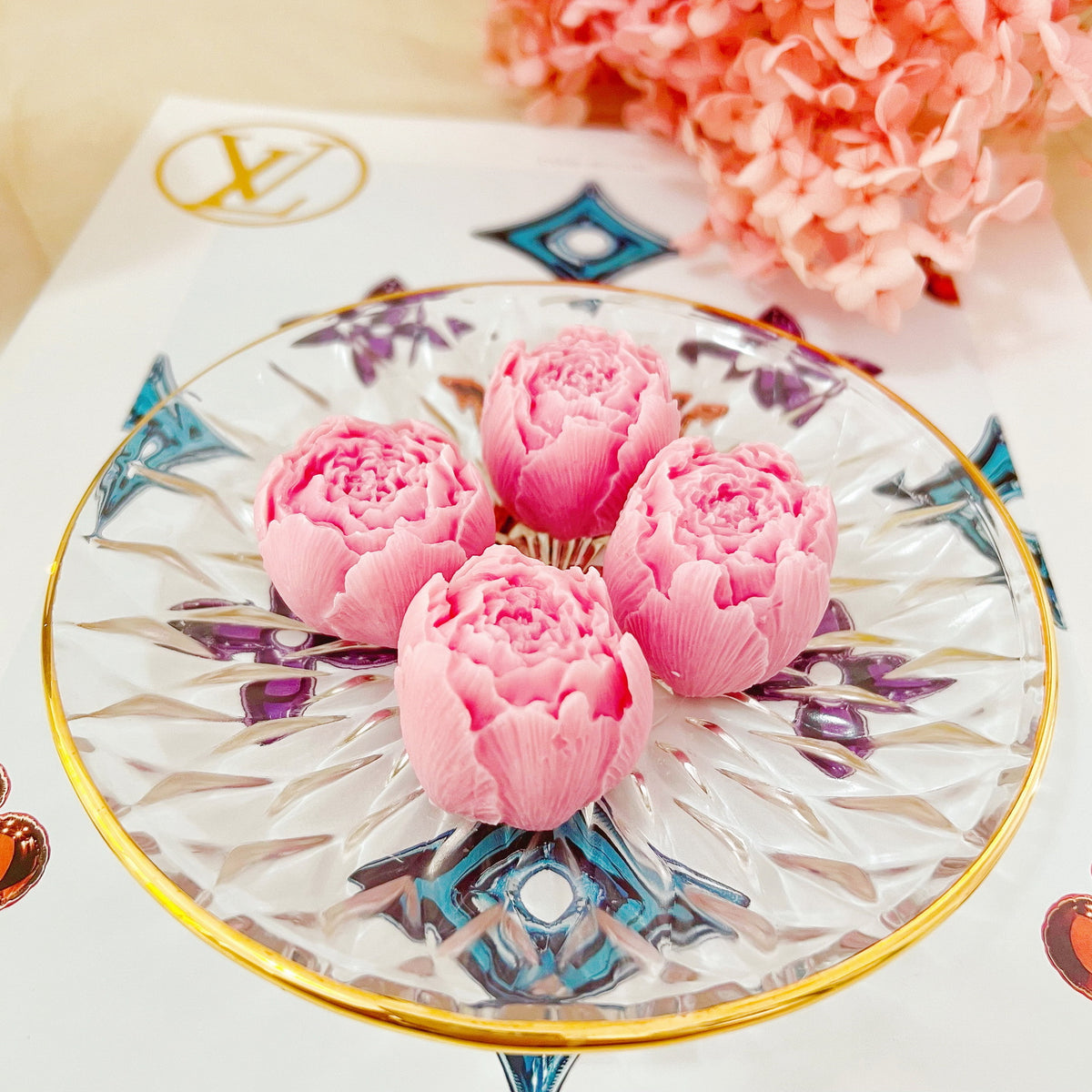 Four handcrafted rosebud soy wax melts by LMJ Candles displayed on a delicate ceramic dish and glazed tray, accentuating their romantic floral scent and eco-friendly qualities.